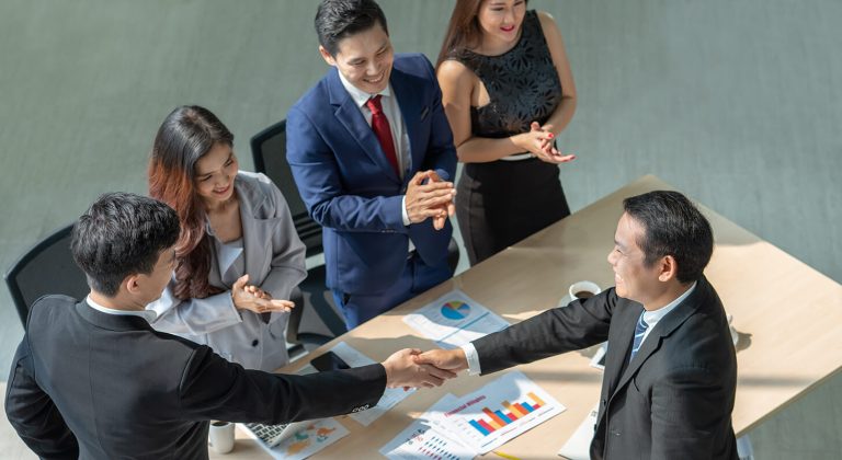 businessmen-shaking-hands-agreement-work-together-after-meeting-office